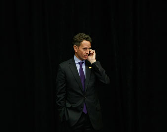 Timothy Geithner talks on his cell phone during President Obama's news conference at the conclusion of the G-20 in Pittsburgh. AP Images</br> 