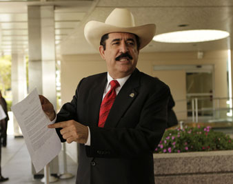 Zelaya points to a State Department document as he speaks to the media following his meeting with Clinton on September 3, 2009. AP Images</br> 