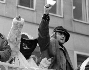 John Lennon and his wife Yoko Ono raise their fists as they join a protest, Feb. 5, 1972. AP Images</br> 