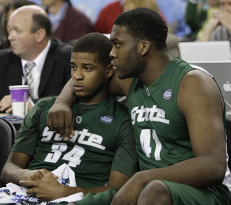 Michigan State players Korie Lucious (34) and Marquise Gray console each other after their 89-72 loss to North Carolina. AP Images</br> 