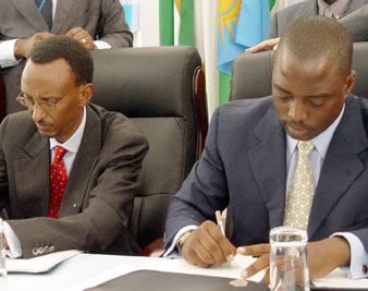 Presidents Paul Kagame of Rwanda and Joseph Kabila of Congo signing a peace declaration on November 20, 2004 KHALFAN SAID/AP IMAGES 