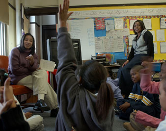 Fourth grade teacher Karolyn McNeil, right, and teacher intern Koresha Braxton, left, work with students at Samuel Mason School AP Images</br> 