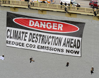 Protesters hang a sign from the West End Bridge before the start of the G-20 summit, Sept. 23, 2009 in Pittsburgh. AP Images</br> 