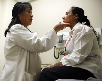 Rulour Torio, MD (examines Pabitra Timsina, a refugee from Bhutan, at the El Franco Lee Health Center in Houston, Texas. Reuters Photos<br/> 