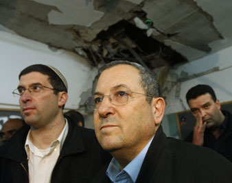 Israel's Defence Minister Barak surveys a damaged classroom after a rocket landed in a school in Beersheba. Reuters Photos<br/> 