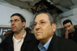 Israel's Defence Minister Barak surveys a damaged classroom after a rocket landed in a school in Beersheba.