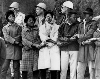 Demonstrators lock arms in front of the Dallas County courthouse in Selma, AL. Sheriff Jim Clark had them all arrested, 1965. CSU Archives/Everett Collection 