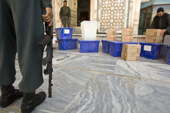  An Afghan policeman stands guard beside voting materials at a polling station in Jamee Mosque in Herat. Reuters Photos<br/> 