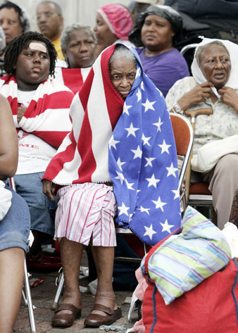Milvertha Hendricks, 84, center waits in the rain with other flood victims outside the convention center in New Orleans, Sept.  AP Images</br> 