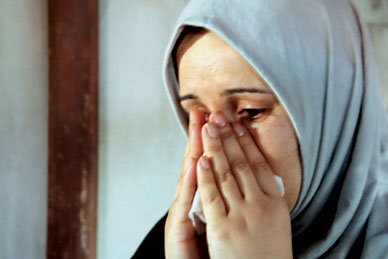 In Damascus, a woman weeps as she describes her family's daily life since they fled Iraq. ANN JONES 