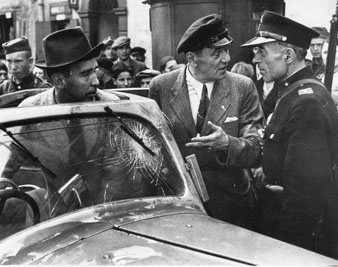 Julien Bryan (behind windshield) watches as his interpreter deals with a Warsaw policeman. Photo courtesy Sam Bryan.  