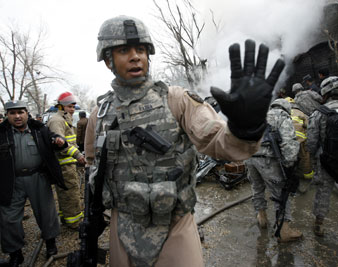A US soldier stops the media from approaching the German embassy after a blast outside the building in Kabul (1/17/09). Reuters Pictures<br/> 