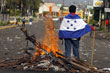 Supporters of Honduras's President Zelaya sing the national anthem outside the presidential house in Tegucigalpa.