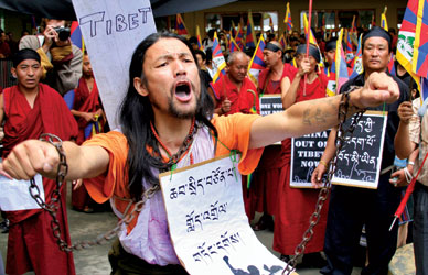 A Tibetan exile in Dharamsala protests the Beijing Olympic Games last August. The poster says, Release Political Prisoners. REUTERS 