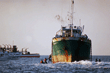 Rescuers approach the <i>Golden Venture</i> in June, 1993.