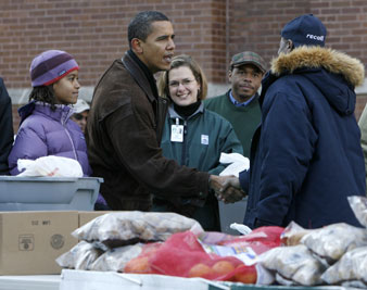 Obama and family helped out at a Chicago Food Bank in December. Reuters Photos<br/> 