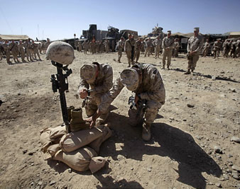 Gen. Lawrence Nicholson, left, and Sgt. Major Hooph pay their respects to Lance Cpl. Joshua Bernard during a memorial service.  AP Images</br> 