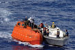 A US Navy team tows the lifeboat where Somali pirates held Capt. Richard Phillips captive.