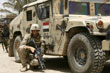 US Marine takes cover behind an Iraqi Army humvee in Amarah, Iraq.