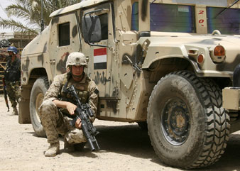 US Marine takes cover behind an Iraqi Army humvee in Amarah, Iraq. AP Images</br> 